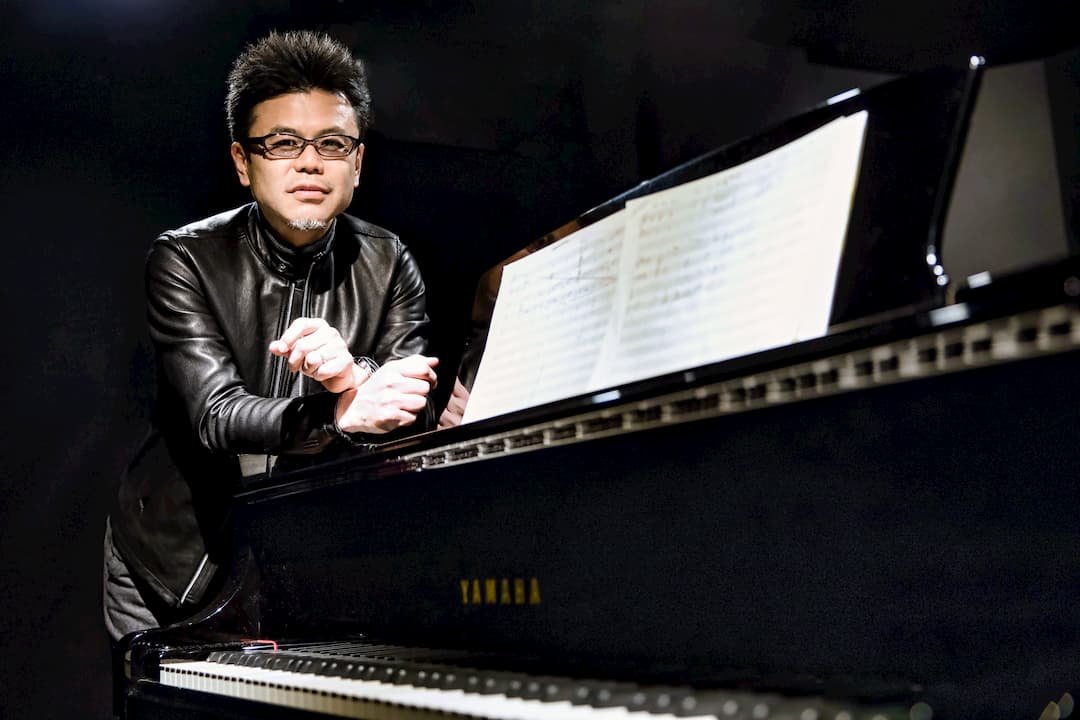 The portrait of Koji Takata with a stage piano